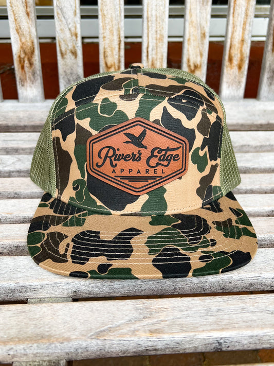 7 Panel River’s Edge Apparel Trucker Hat with Leather Patch - Old School Camo